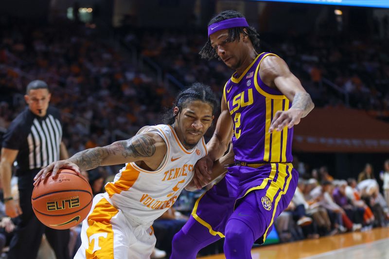 Feb 7, 2024; Knoxville, Tennessee, USA; Tennessee Volunteers guard Zakai Zeigler (5) moves the ball against LSU Tigers guard Mike Williams III (2) during the first half at Thompson-Boling Arena at Food City Center. Mandatory Credit: Randy Sartin-USA TODAY Sports