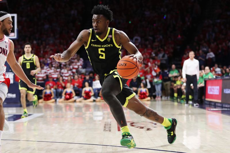 Feb 2, 2023; Tucson, Arizona, USA; Oregon Ducks guard Jermaine Couisnard (5) drives to the net against Arizona Wildcats guard Kylan Boswell (4) in the first half at McKale Center. Mandatory Credit: Zachary BonDurant-USA TODAY Sports