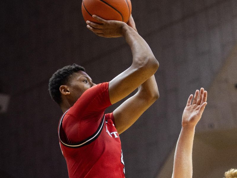 Jan 2, 2025; Bloomington, Indiana, USA; Rutgers Scarlet Knights guard Ace Bailey (4) shoots the ball while Indiana Hoosiers forward Luke Goode (10) defends in the second half at Simon Skjodt Assembly Hall. Mandatory Credit: Trevor Ruszkowski-Imagn Images