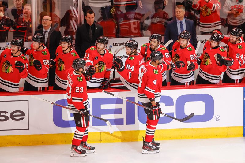 Mar 26, 2024; Chicago, Illinois, USA; Chicago Blackhawks defenseman Seth Jones (4) celebrates with teammates after scoring against the Calgary Flames during the first period at United Center. Mandatory Credit: Kamil Krzaczynski-USA TODAY Sports