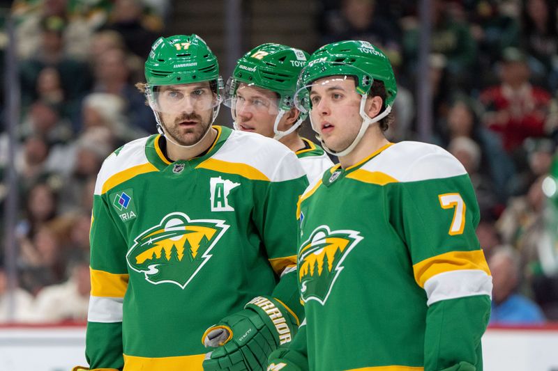 Jan 25, 2025; Saint Paul, Minnesota, USA; Minnesota Wild left wing Marcus Foligno (17) and defenseman Brock Faber (7) talk before a face-off against the Calgary Flames in the third period at Xcel Energy Center. Mandatory Credit: Matt Blewett-Imagn Images