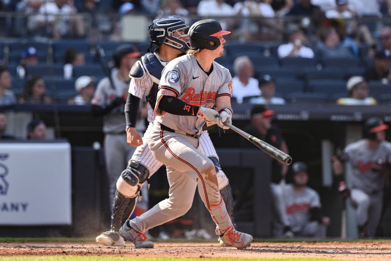Jun 20, 2024; Bronx, New York, USA; Baltimore Orioles catcher Adley Rutschman (35) hits a double against the New York Yankees during the third inning at Yankee Stadium. Mandatory Credit: John Jones-USA TODAY Sports