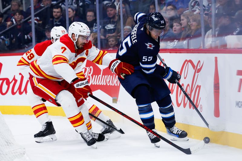 Sep 27, 2025; Winnipeg, Manitoba, CAN;  Winnipeg Jets forward Mark Scheifele (55) shields the puck from Calgary Flames defenseman Kevin Bahl (7) during the second period at Canada Life Centre. Mandatory Credit: Terrence Lee-Imagn Images