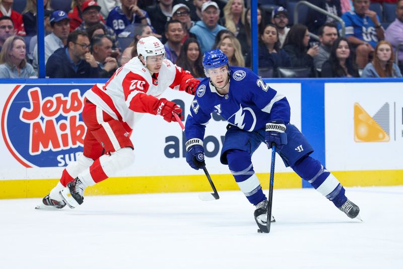 Mar 12, 2026; Tampa, Florida, USA; Tampa Bay Lightning center Brayden Point (21) controls the puck from Detroit Red Wings defenseman Albert Johansson (20) in the first period at Benchmark International Arena. Mandatory Credit: Nathan Ray Seebeck-Imagn Images