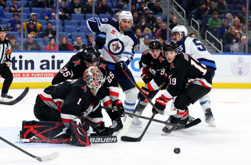 Dec 5, 2024; Buffalo, New York, USA;  Buffalo Sabres goaltender Ukko-Pekka Luukkonen (1) makes a save as Winnipeg Jets right wing Nino Niederreiter (62) and Buffalo Sabres center Peyton Krebs (19) look for the rebound during the third period at KeyBank Center. Mandatory Credit: Timothy T. Ludwig-Imagn Images