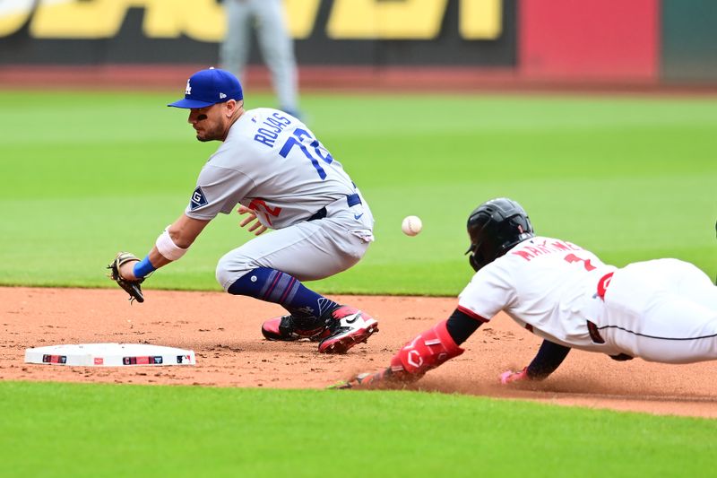 May 28, 2025; Cleveland, Ohio, USA; Los Angeles Dodgers second baseman Miguel Rojas (72) misses the ball as Cleveland Guardians center fielder Angel Martinez (1) dives into second with a double during the first inning at Progressive Field. Mandatory Credit: Ken Blaze-Imagn Images