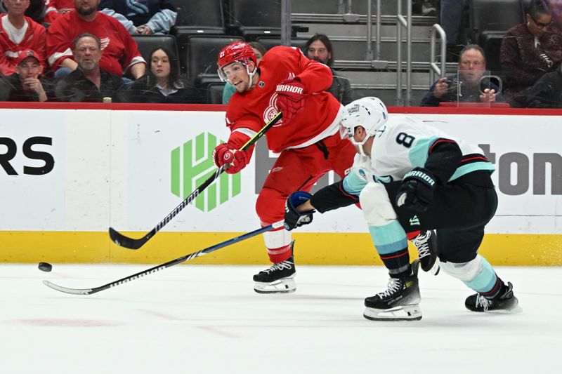 Oct 24, 2023; Detroit, Michigan, USA; Detroit Red Wings center Austin Czarnik (21) takes a shot on goal against Seattle Kraken defenseman Brian Dumoulin (8) in the second period at Little Caesars Arena. Mandatory Credit: Lon Horwedel-USA TODAY Sports