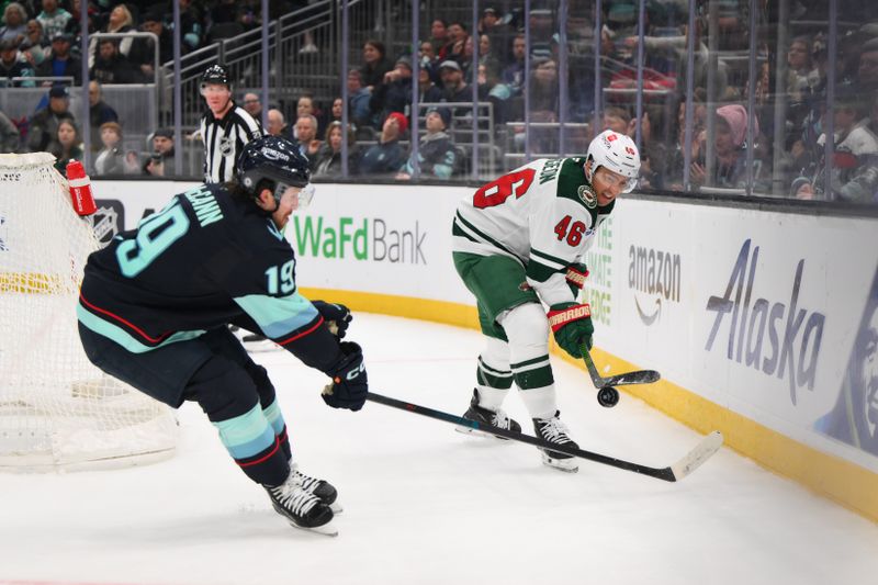 Mar 4, 2025; Seattle, Washington, USA; Minnesota Wild defenseman Jared Spurgeon (46) passes the puck past Seattle Kraken left wing Jared McCann (19) during the third period at Climate Pledge Arena. Mandatory Credit: Steven Bisig-Imagn Images