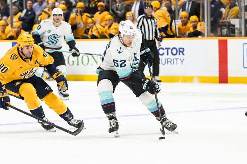 Oct 15, 2024; Nashville, Tennessee, USA;  Seattle Kraken defenseman Brandon Montour (62) takes shot on goal against the Nashville Predators during the second period at Bridgestone Arena. Mandatory Credit: Steve Roberts-Imagn Images