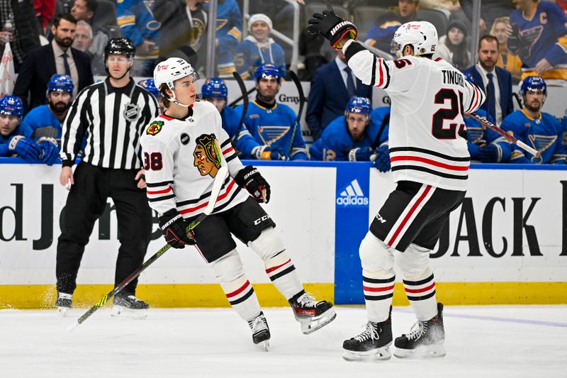 Dec 23, 2023; St. Louis, Missouri, USA;  Chicago Blackhawks center Connor Bedard (98) celebrates with defenseman Jarred Tinordi (25) after scoring against the St. Louis Blues during the first period at Enterprise Center. Mandatory Credit: Jeff Curry-USA TODAY Sports
