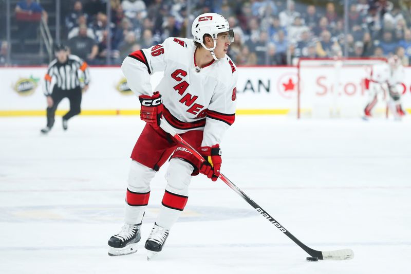 Dec 4, 2023; Winnipeg, Manitoba, CAN;   Carolina Hurricanes forward Teuvo Teravainen (86) skates into the Winnipeg Jets zone during the first period at Canada Life Centre. Mandatory Credit: Terrence Lee-USA TODAY Sports