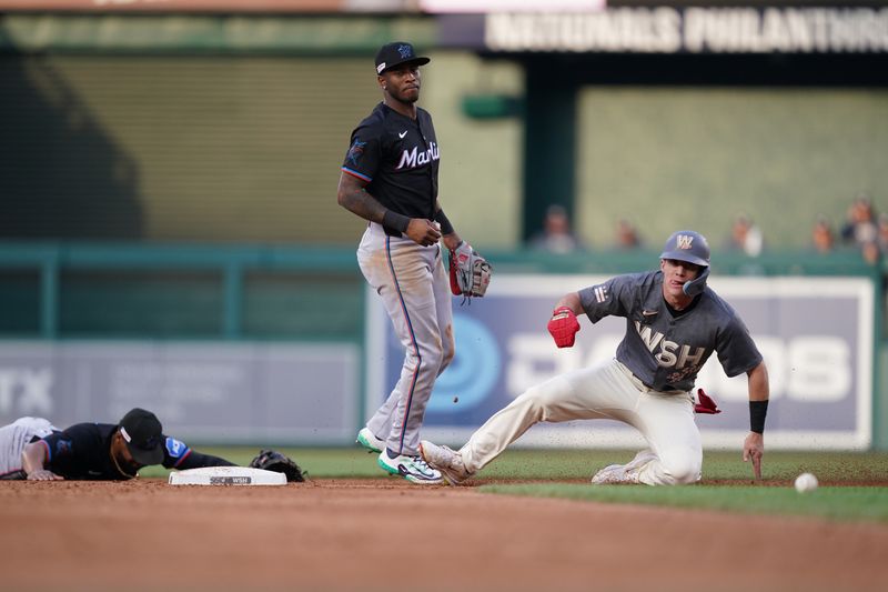 Jun 14, 2024; Washington, District of Columbia, USA; Washington Nationals center fielder Jacob Young (30) slides into second base after an error by Miami Marlins shortstop Tim Anderson (7) in the third inning at Nationals Park. Mandatory Credit: Amber Searls-USA TODAY Sports