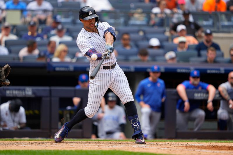 Jul 8, 2023; Bronx, New York, USA; New York Yankees right fielder Giancarlo Stanton (27) hits a two run home run to right field against the Chicago Cubs during the fifth inning at Yankee Stadium. Mandatory Credit: Gregory Fisher-USA TODAY Sports