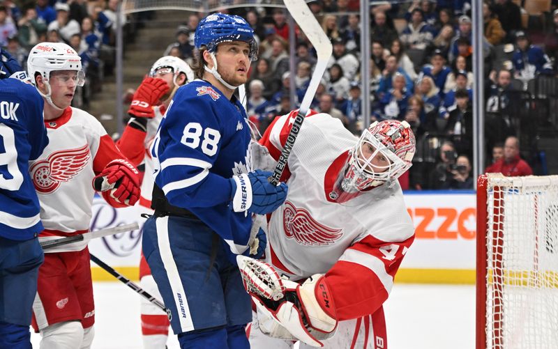 Jan 14, 2024; Toronto, Ontario, CAN;  Detroit Red Wings goalie James Reimer (47) is knocked off balance after making a save against Toronto Maple Leafs forward William Nylander in the third period at Scotiabank Arena. Mandatory Credit: Dan Hamilton-USA TODAY Sports