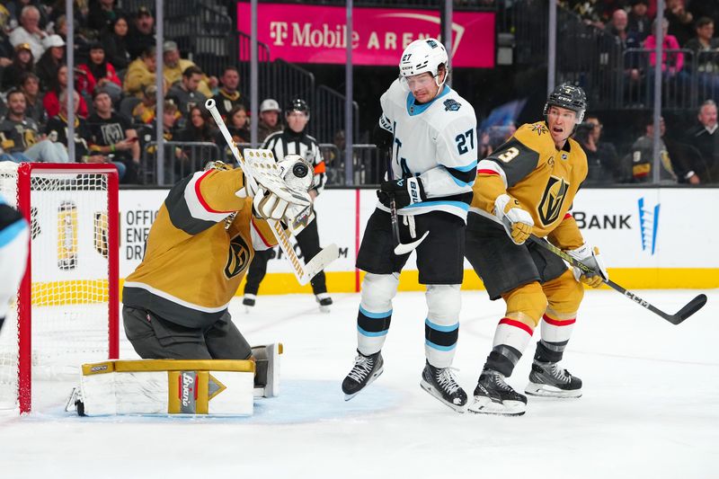 Nov 2, 2024; Las Vegas, Nevada, USA; Vegas Golden Knights goaltender Adin Hill (33) makes a save behind Utah Hockey Club center Barrett Hayton (27) and Knights defenseman Brayden McNabb (3) during the third period at T-Mobile Arena. Mandatory Credit: Stephen R. Sylvanie-Imagn Images