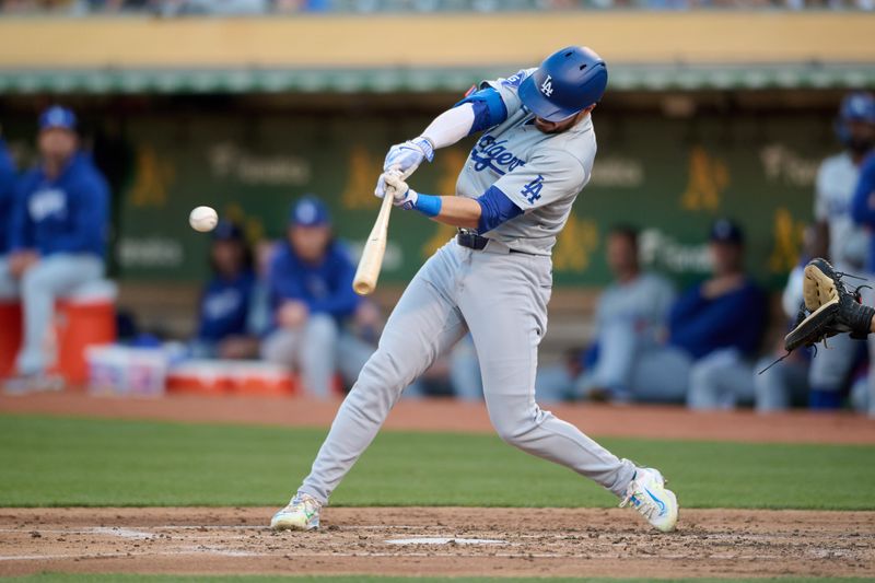 Aug 3, 2024; Oakland, California, USA; Los Angeles Dodgers infielder Gavin Lux (9) hits an RBI single against the Oakland Athletics during the third inning at Oakland-Alameda County Coliseum. Mandatory Credit: Robert Edwards-USA TODAY Sports