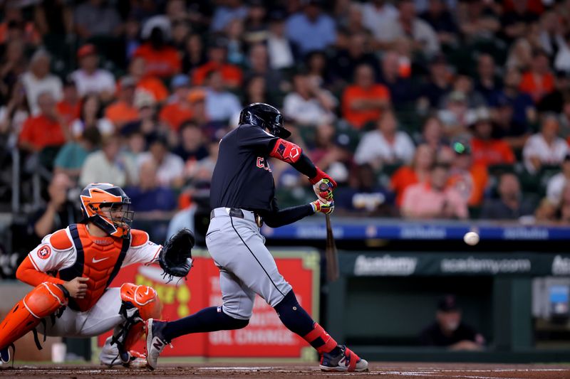 Apr 30, 2024; Houston, Texas, USA; Cleveland Guardians second base Andres Gimenez (0) hits a single against the Houston Astros during the first inning at Minute Maid Park. Mandatory Credit: Erik Williams-USA TODAY Sports