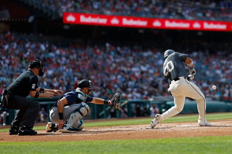May 25, 2024; Washington, District of Columbia, USA; Washington Nationals catcher Keibert Ruiz (20) hits a sacrifice fly RBI against the Seattle Mariners during the second inning at Nationals Park. Mandatory Credit: Geoff Burke-USA TODAY Sports