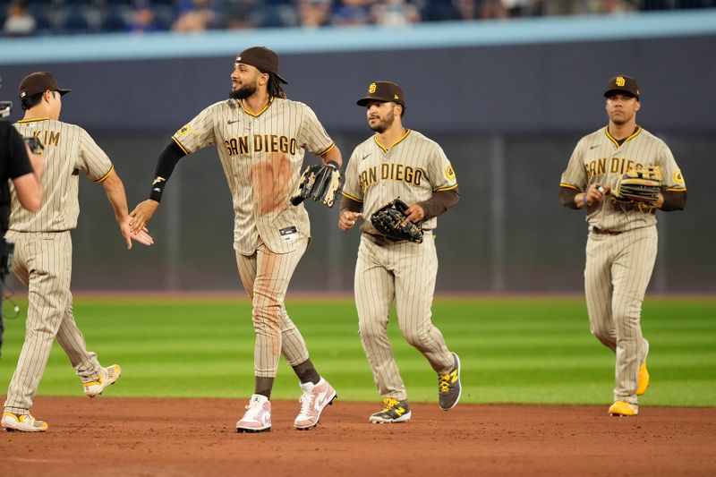 Jul 18, 2023; Toronto, Ontario, CAN;  San Diego Padres right fielder Fernando Tatis Jr. (23) leads the outfield off the field after a win over the Toronto Blue Jays at Rogers Centre. Mandatory Credit: John E. Sokolowski-USA TODAY Sports