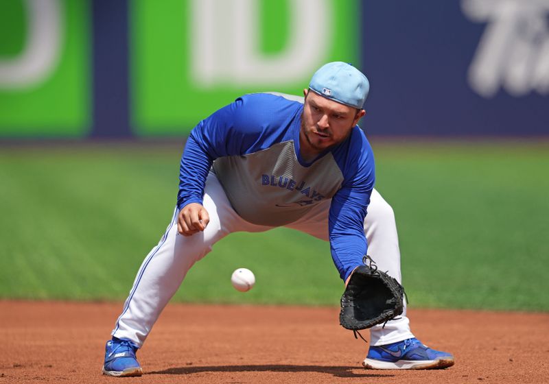 May 20, 2024; Toronto, Ontario, CAN; Toronto Blue Jays catcher Alejandro Kirk (30) fields balls during batting practice before a game against the Chicago White Sox at Rogers Centre. Mandatory Credit: Nick Turchiaro-USA TODAY Sports