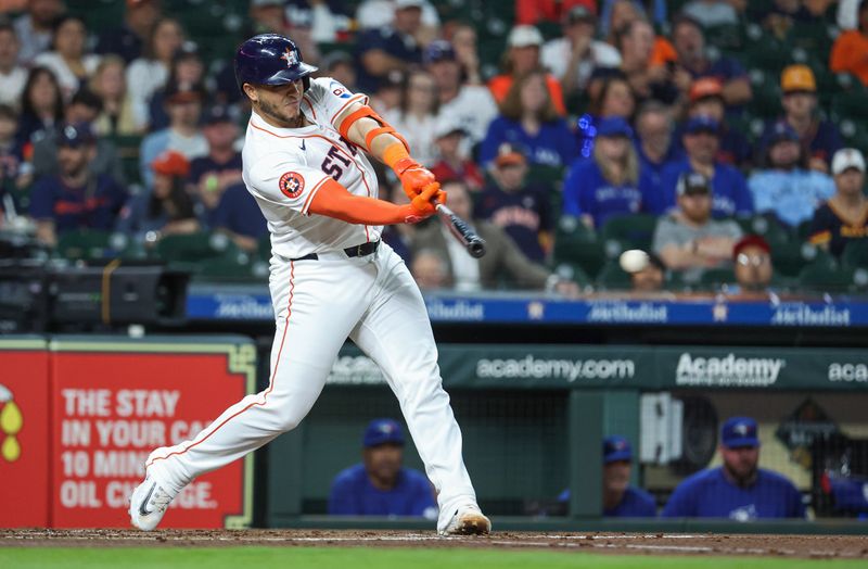 Apr 3, 2024; Houston, Texas, USA; Houston Astros catcher Yainer Diaz (21) hits a single during the first inning against the Toronto Blue Jays at Minute Maid Park. Mandatory Credit: Troy Taormina-USA TODAY Sports