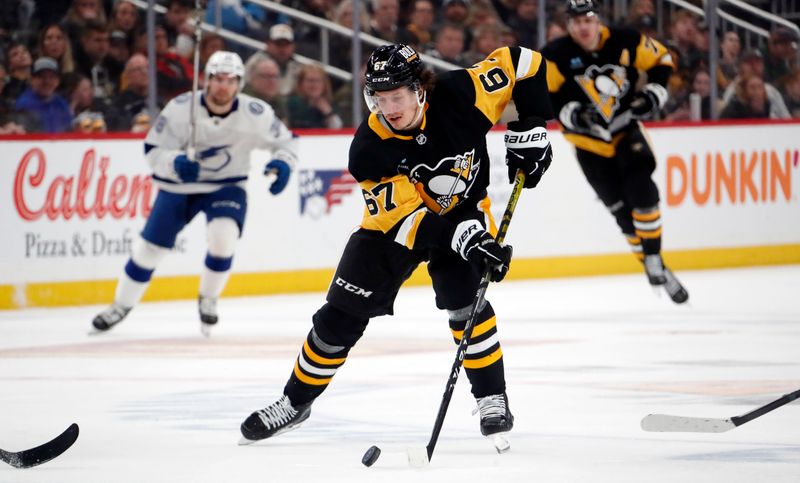 Apr 6, 2024; Pittsburgh, Pennsylvania, USA;  Pittsburgh Penguins right wing Rickard Rakell (67) moves the puck up ice against the Tampa Bay Lightning during the third period at PPG Paints Arena. The Penguins won 5-4. Mandatory Credit: Charles LeClaire-USA TODAY Sports