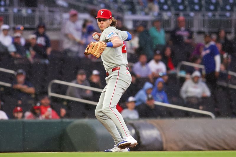 Apr 10, 2025; Atlanta, Georgia, USA; Philadelphia Phillies third baseman Alec Bohm (28) throws a runner out at first against the Atlanta Braves in the second inning at Truist Park. Mandatory Credit: Brett Davis-Imagn Images