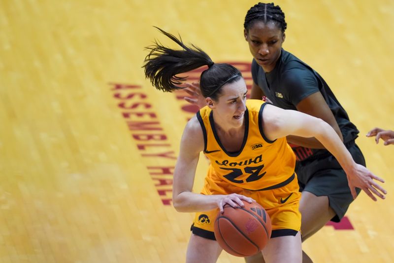 Feb 22, 2024; Bloomington, Indiana, USA;  Iowa Hawkeyes guard Caitlin Clark (22) dribbles the ball against Indiana Hoosiers guard Chloe Moore-McNeil (22) in the first half at Simon Skjodt Assembly Hall. Mandatory Credit: Aaron Doster-USA TODAY Sports