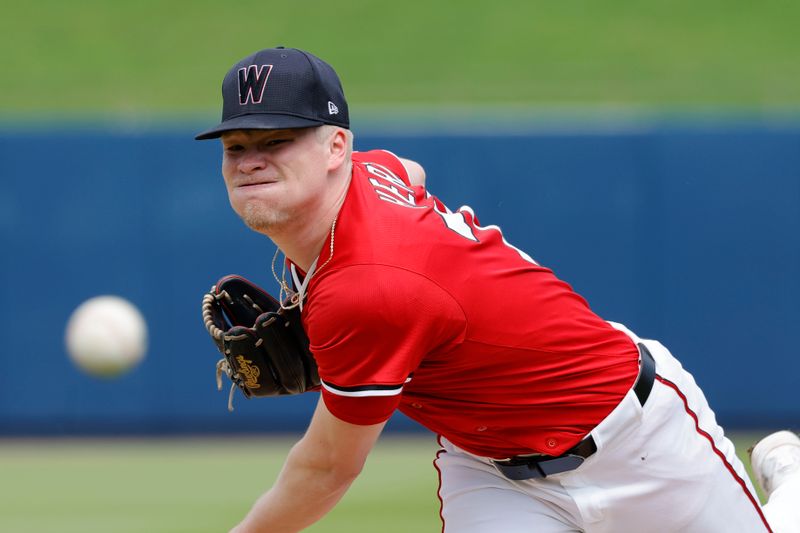 Feb 26, 2025; West Palm Beach, Florida, USA; Washington Nationals pitcher DJ Herz (77) throws a pitch before the first inning  against the Houston Astros at CACTI Park of the Palm Beaches. Mandatory Credit: Reinhold Matay-Imagn Images