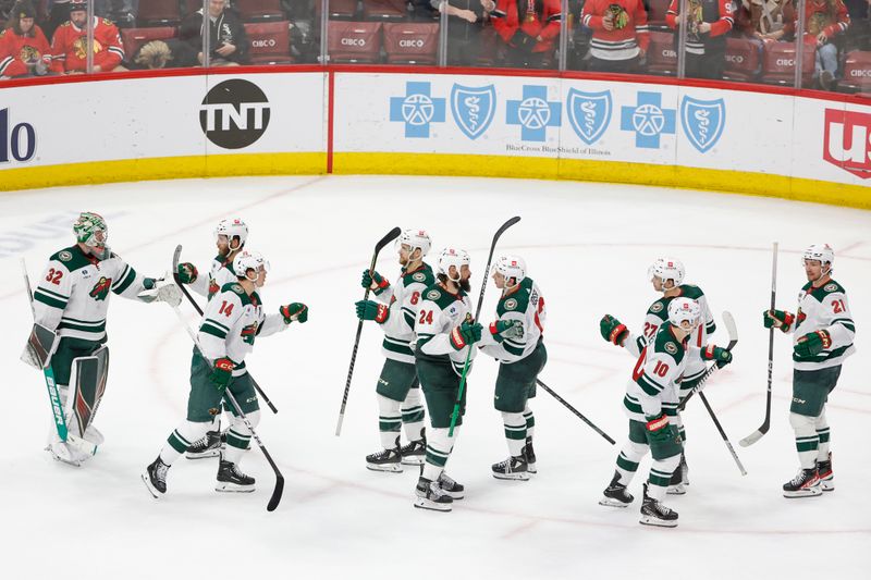 Feb 7, 2024; Chicago, Illinois, USA; Minnesota Wild goaltender Filip Gustavsson (32) celebrates with teammates after defeating the Chicago Blackhawks at United Center. Mandatory Credit: Kamil Krzaczynski-USA TODAY Sports