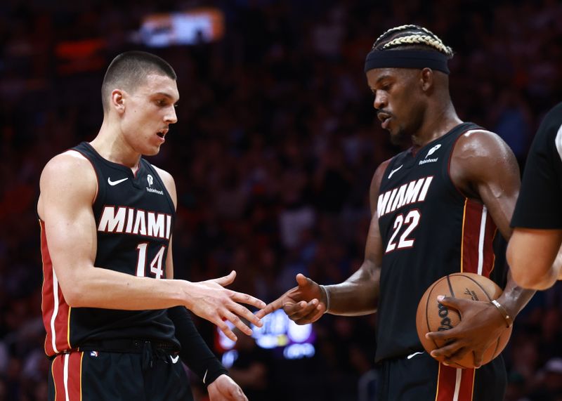 MIAMI, FLORIDA - NOVEMBER 04: Jimmy Butler #22 of the Miami Heat high fives Tyler Herro #14  after he makes his free throw against the Sacramento Kings during the second half at Kaseya Center on November 04, 2024 in Miami, Florida. NOTE TO USER: User expressly acknowledges and agrees that, by downloading and or using this Photograph, user is consenting to the terms and conditions of the Getty Images License Agreement. (Photo by Carmen Mandato/Getty Images)