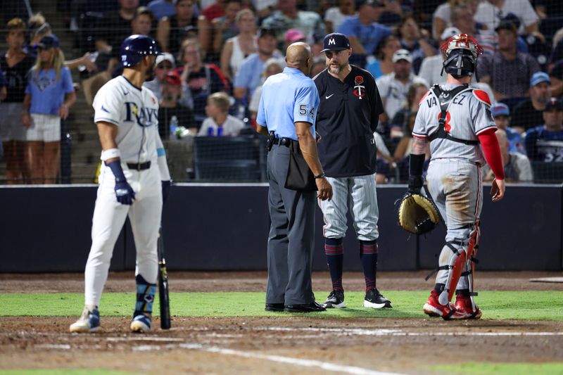 May 26, 2025; Tampa, Florida, USA; Minnesota Twins manager Rocco Baldelli (5) talks to umpire CB Bucknor (54) during a gem against the Tampa Bay Rays in the sixth inning at George M. Steinbrenner Field. Mandatory Credit: Nathan Ray Seebeck-Imagn Images