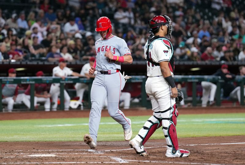 Jun 13, 2024; Phoenix, Arizona, USA; Los Angeles Angels catcher Logan O'Hoppe (14) scores a run against the Arizona Diamondbacks during the third inning at Chase Field. Mandatory Credit: Joe Camporeale-USA TODAY Sports