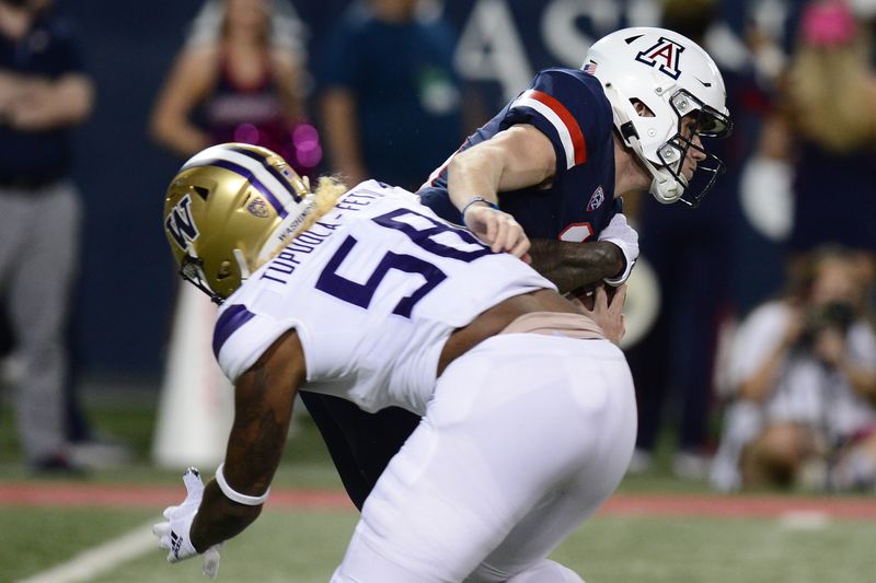 Oct 22, 2021; Tucson, Arizona, USA; Arizona Wildcats quarterback Will Plummer (15) is sacked by Washington Huskies linebacker Zion Tupuola-Fetui (58) during the first half at Arizona Stadium. Mandatory Credit: Joe Camporeale-USA TODAY Sports