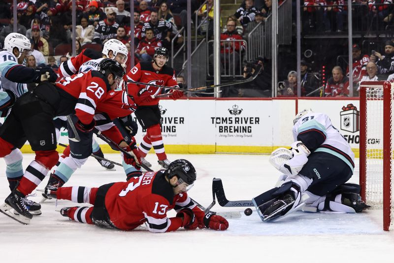 Dec 6, 2024; Newark, New Jersey, USA; Seattle Kraken goaltender Philipp Grubauer (31) makes a save against the New Jersey Devils during the second period at Prudential Center. Mandatory Credit: Ed Mulholland-Imagn Images