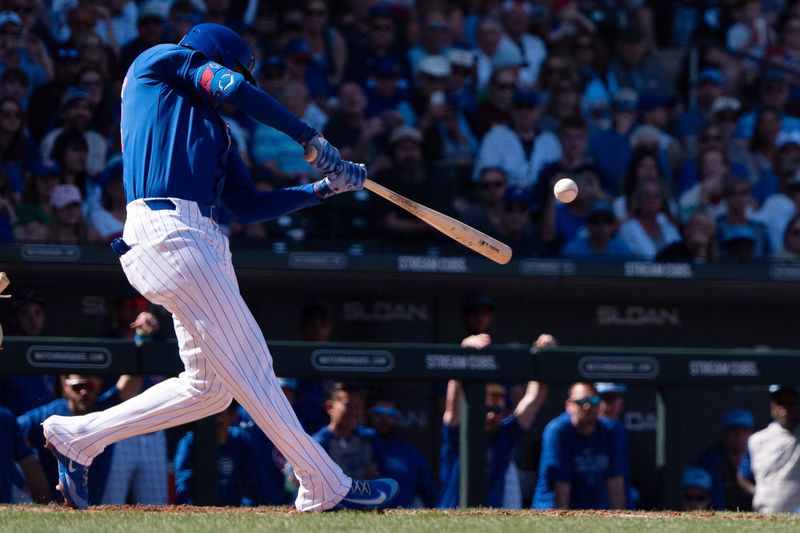 Mar 9, 2024; Mesa, Arizona, USA; Chicago Cubs outfielder Cody Bellinger (24) hits a ground-rule double on a line drive to right field to score infielder Garrett Cooper (not pictured) and infielder Nico Hoerner (not pictured) against the Colorado Rockies in the third of a spring training game at Sloan Park. Mandatory Credit: Allan Henry-USA TODAY Sports