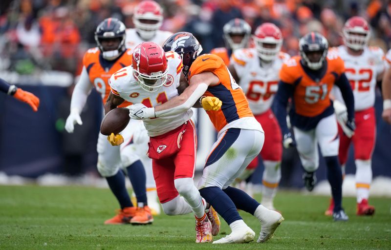 Kansas City Chiefs wide receiver Marquez Valdes-Scantling (11) fumbles while bring tckled by Denver Broncos linebacker Josey Jewell (47) in the first half of an NFL football game Sunday, Oct. 29, 2023, in Denver. (AP Photo/David Zalubowski)