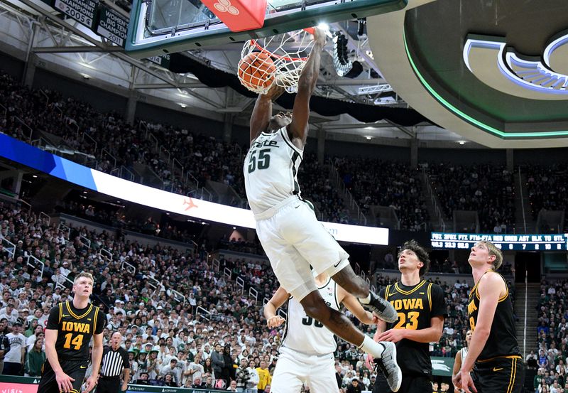 Dec 2, 2025; East Lansing, Michigan, USA;  Michigan State Spartans forward Coen Carr (55) dunks the ball during the second half against the Iowa Hawkeyes Jack Breslin Student Events Center. Mandatory Credit: Dale Young-Imagn Images