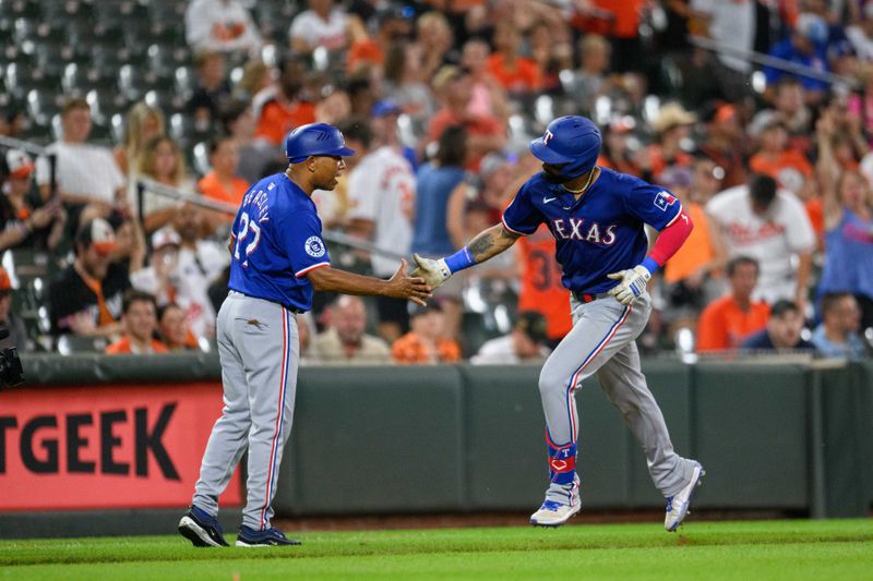 Jun 30, 2024; Baltimore, Maryland, USA; Texas Rangers outfielder Derek Hill (40) celebrates with third base coach Tony Beasley (27) after hitting home run during the fifth inning against the Baltimore Orioles at Oriole Park at Camden Yards. Mandatory Credit: Reggie Hildred-USA TODAY Sports