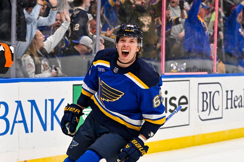 Nov 3, 2023; St. Louis, Missouri, USA;  St. Louis Blues left wing Jake Neighbours (63) reacts after scoring against the New Jersey Devils during the second period at Enterprise Center. Mandatory Credit: Jeff Curry-USA TODAY Sports