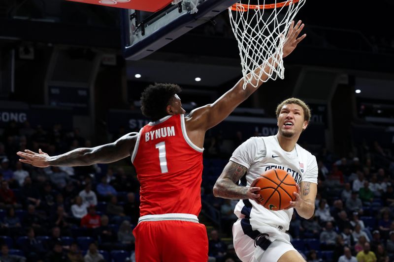 Mar 4, 2026; University Park, Pennsylvania, USA; Penn State Nittany Lions guard Eli Rice (11) drives the ball to the basket as Ohio State Buckeyes forward Amare Bynum (1) defends during the first half at Bryce Jordan Center. Mandatory Credit: Matthew O'Haren-Imagn Images