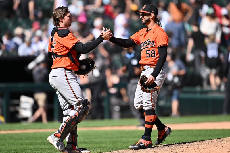 May 25, 2024; Chicago, Illinois, USA;  Baltimore Orioles catcher Adley Rutschman (35) and pitcher Cionel Perez (58) celebrate after defeating the Chicago White Sox at Guaranteed Rate Field. Mandatory Credit: Jamie Sabau-USA TODAY Sports