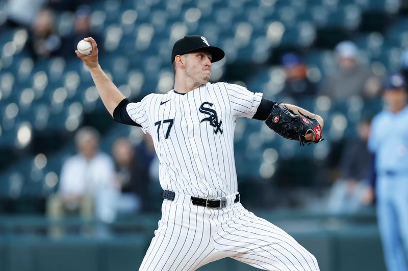 May 27, 2024; Chicago, Illinois, USA; Chicago White Sox starting pitcher Chris Flexen (77) delivers a pitch against the Toronto Blue Jays during the first inning at Guaranteed Rate Field. Mandatory Credit: Kamil Krzaczynski-USA TODAY Sports