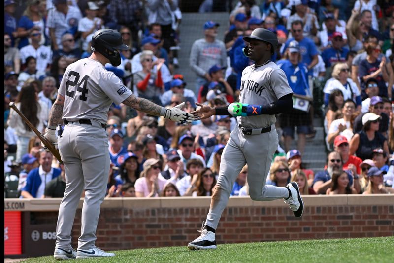 Sep 8, 2024; Chicago, Illinois, USA;  New York Yankees third baseman Jazz Chisholm Jr. (13), right, high fives outfielder Alex Verdugo (24) after scoring against the Chicago Cubs during the third inning  at Wrigley Field. Mandatory Credit: Matt Marton-Imagn Images