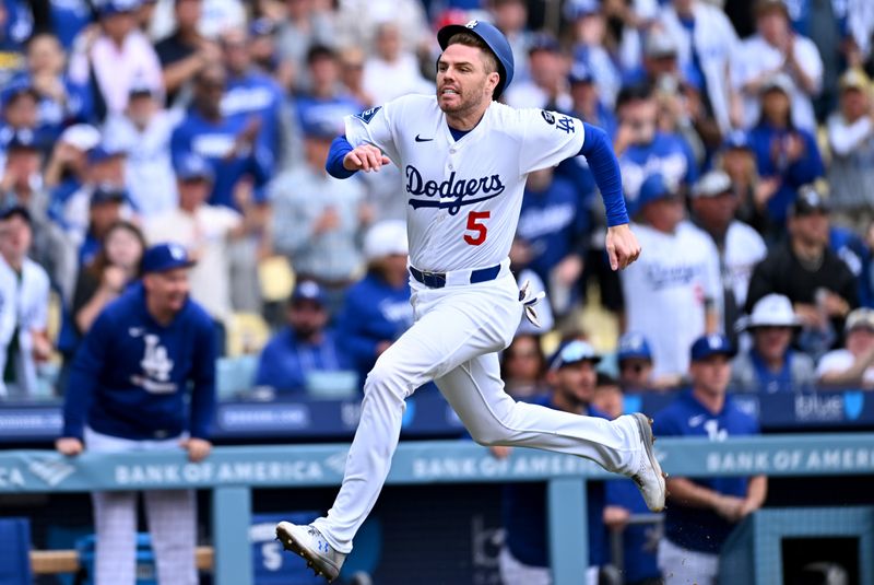 Apr 27, 2025; Los Angeles, California, USA; Los Angeles Dodgers first baseman Freddie Freeman (5) scores during the first inning against the Pittsburgh Pirates at Dodger Stadium. Mandatory Credit: Jonathan Hui-Imagn Images