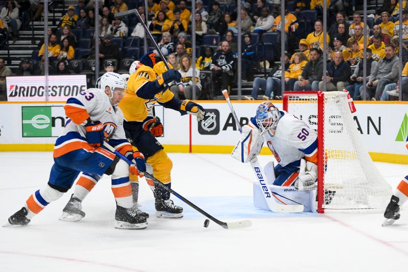 Apr 8, 2025; Nashville, Tennessee, USA;  New York Islanders goaltender Marcus Hogberg (50) blocks the shot of Nashville Predators center Ryan O'Reilly (90) during the third period at Bridgestone Arena. Mandatory Credit: Steve Roberts-Imagn Images
