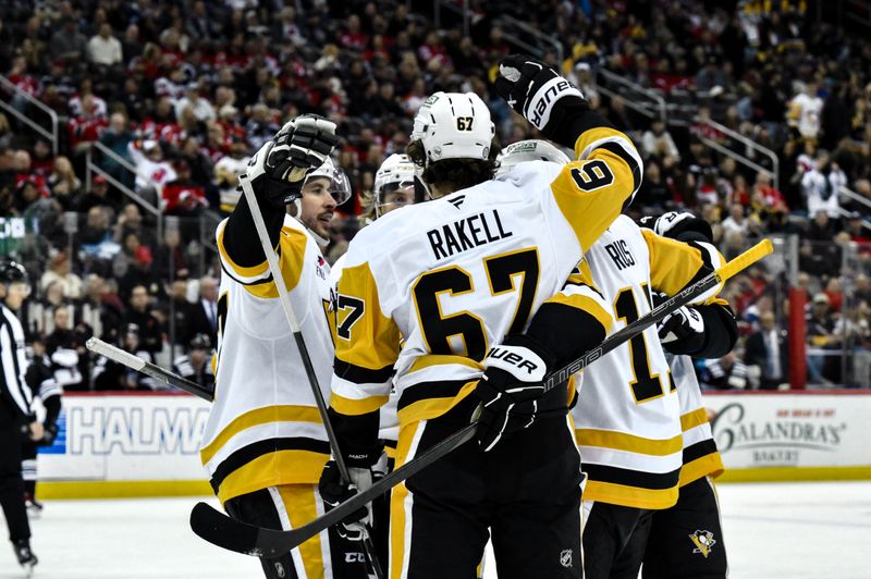 Apr 11, 2025; Newark, New Jersey, USA; Pittsburgh Penguins right wing Bryan Rust (17) celebrates with teammates after scoring a goal against the New Jersey Devils during the third period at Prudential Center. Mandatory Credit: John Jones-Imagn Images