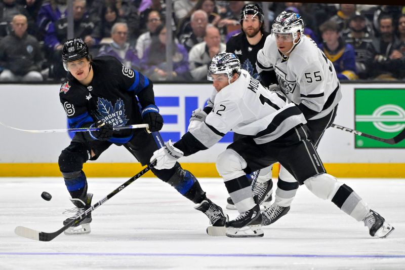 Jan 2, 2024; Los Angeles, California, USA; Toronto Maple Leafs right wing William Nylander (88) sends the puck past Los Angeles Kings left wing Trevor Moore (12) at Crypto.com Arena. Mandatory Credit: Jayne Kamin-Oncea-USA TODAY Sports