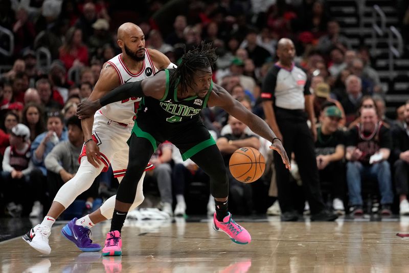 CHICAGO, ILLINOIS - FEBRUARY 22: Jrue Holiday #4 of the Boston Celtics dribbles the ball against Jevon Carter #5 of the Chicago Bulls during the second half at the United Center on February 22, 2024 in Chicago, Illinois. NOTE TO USER: User expressly acknowledges and agrees that, by downloading and or using this photograph, User is consenting to the terms and conditions of the Getty Images License Agreement. (Photo by Patrick McDermott/Getty Images)