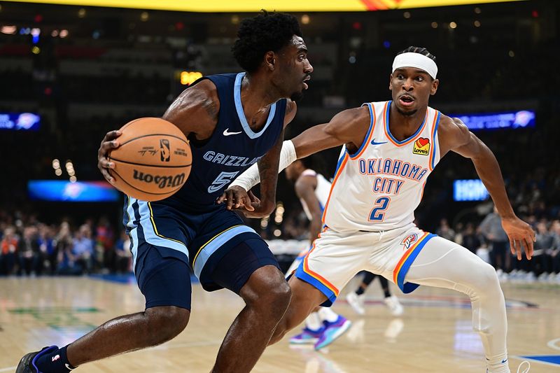 OKLAHOMA CITY, OKLAHOMA - DECEMBER 18: Vince Williams Jr. #5 of the Memphis Grizzlies looks to drive the ball while being defended by Shai Gilgeous-Alexander #2 of the Oklahoma City Thunder during the first half at Paycom Center on December 18, 2023 in Oklahoma City, Oklahoma. NOTE TO USER: User expressly acknowledges and agrees that, by downloading and or using this Photograph, user is consenting to the terms and conditions of the Getty Images License Agreement. (Photo by Joshua Gateley/Getty Images)